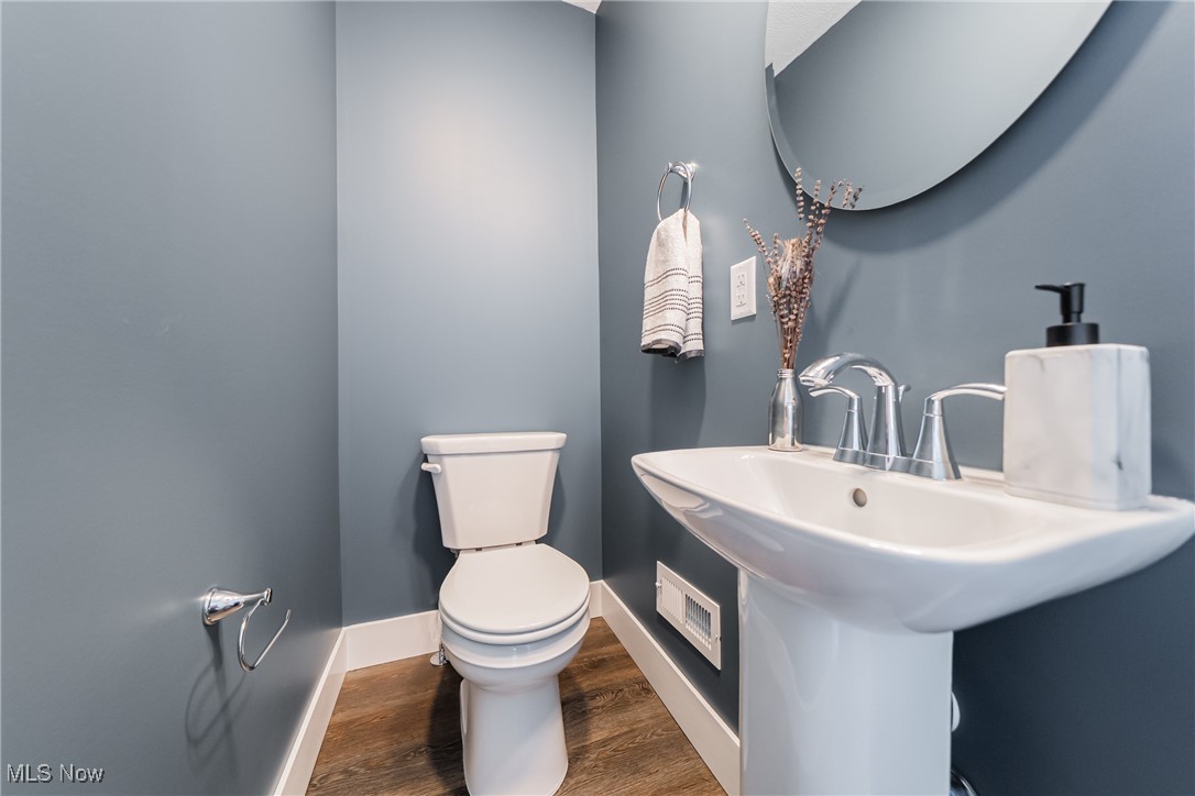 3817 Summit Park Road Cleveland Heights, OH 44121 - Photo 13 of 29 Half bathroom with wood-look floors, toilet, and a sink