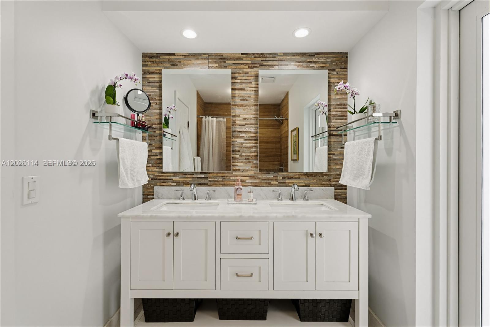 9641 Southwest 66th Street Miami, FL 33173 - Photo 32 of 57 a bathroom with a double vanity sink and a mirror