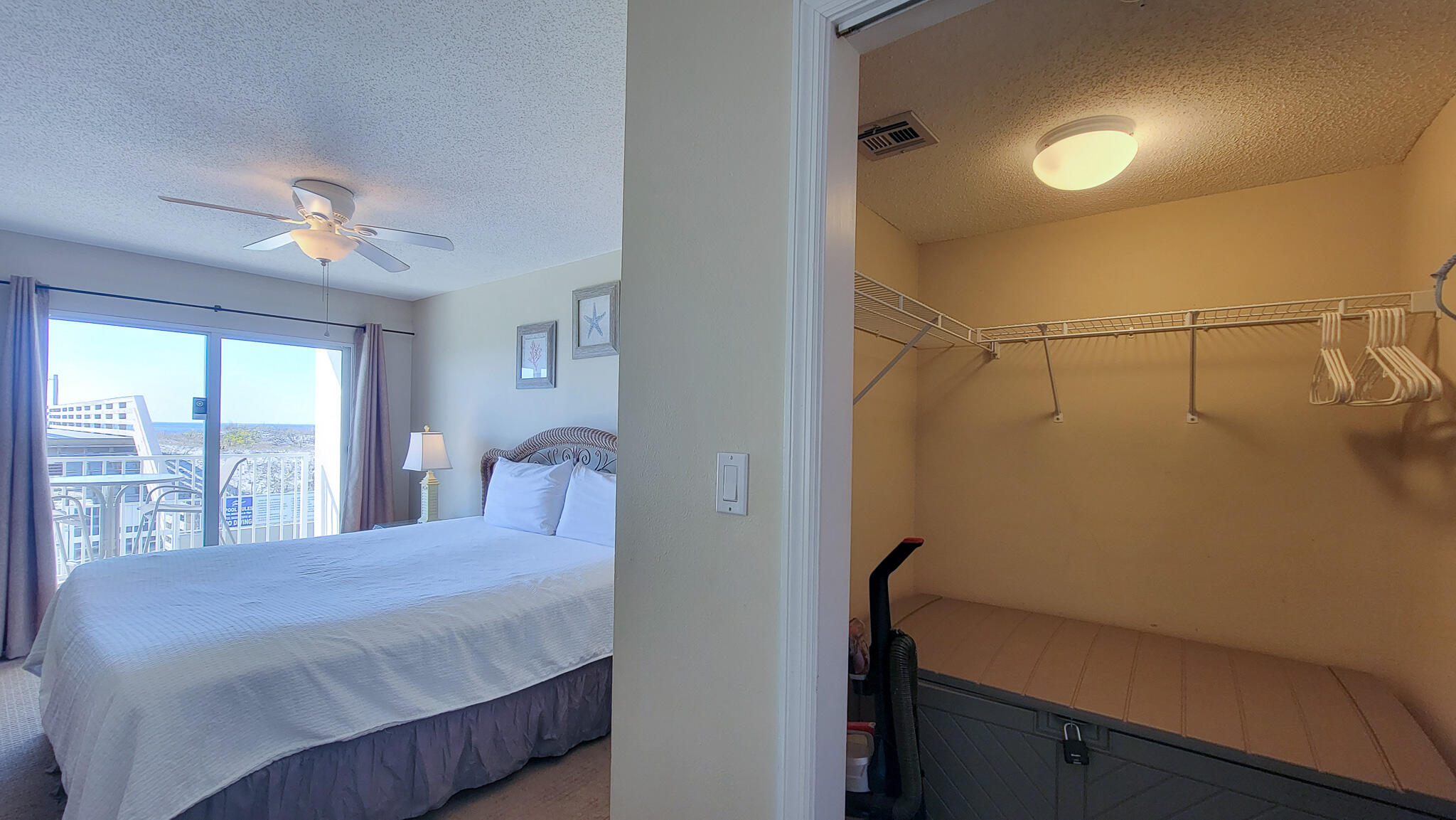 376 Santa Rosa Boulevard, Unit 115 Fort Walton Beach, FL 32548 - Photo 16 of 37 a bedroom with a bed and a chandelier