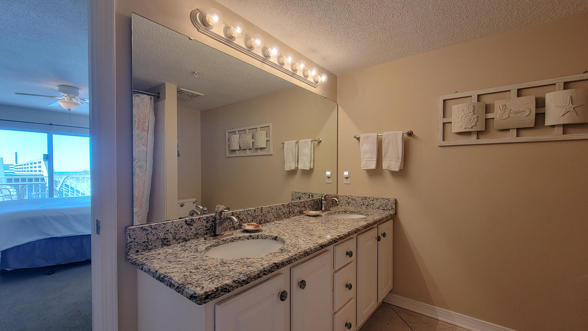 376 Santa Rosa Boulevard, Unit 115 Fort Walton Beach, FL 32548 - Photo 18 of 37 a bathroom with a granite countertop sink and a mirror