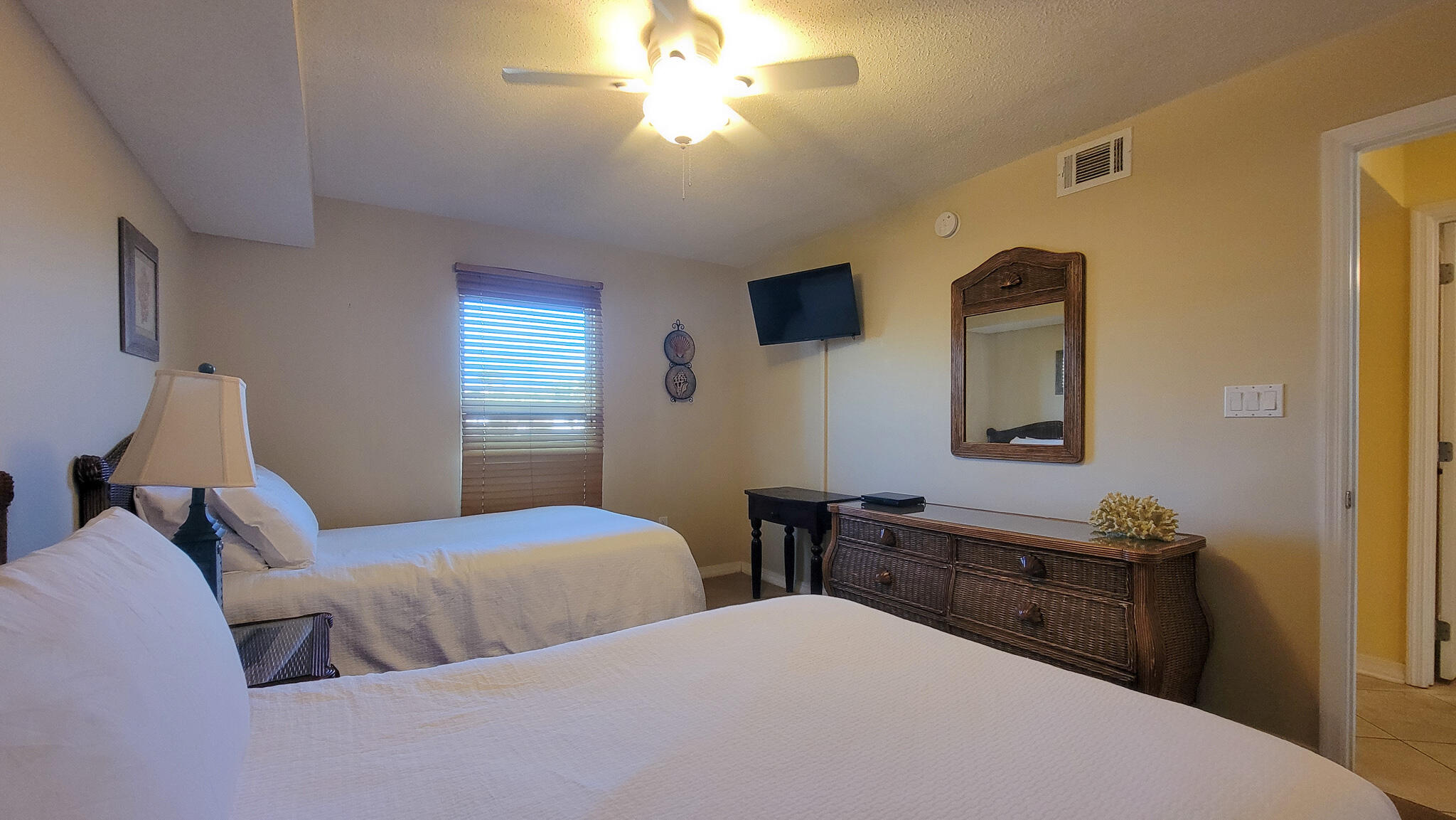 376 Santa Rosa Boulevard, Unit 115 Fort Walton Beach, FL 32548 - Photo 20 of 37 a bedroom with two beds and a dresser