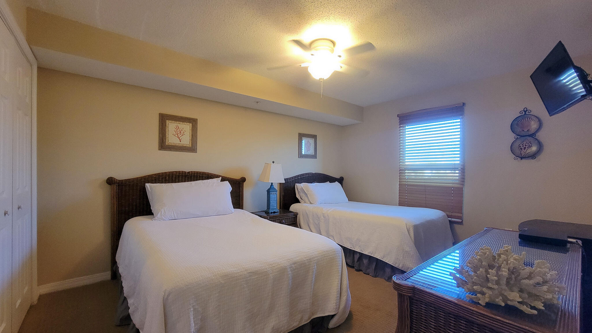 376 Santa Rosa Boulevard, Unit 115 Fort Walton Beach, FL 32548 - Photo 21 of 37 a bedroom with two beds and a chandelier