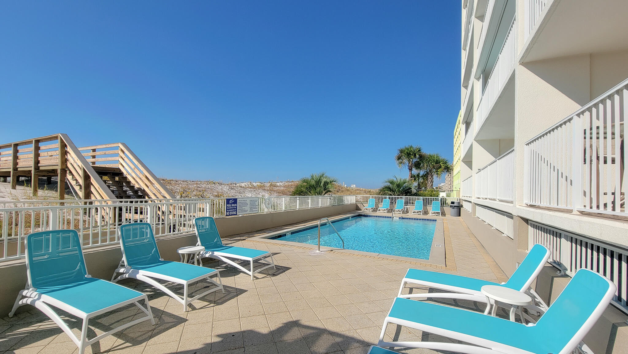 376 Santa Rosa Boulevard, Unit 115 Fort Walton Beach, FL 32548 - Photo 26 of 37 a view of a patio with chairs and potted plants