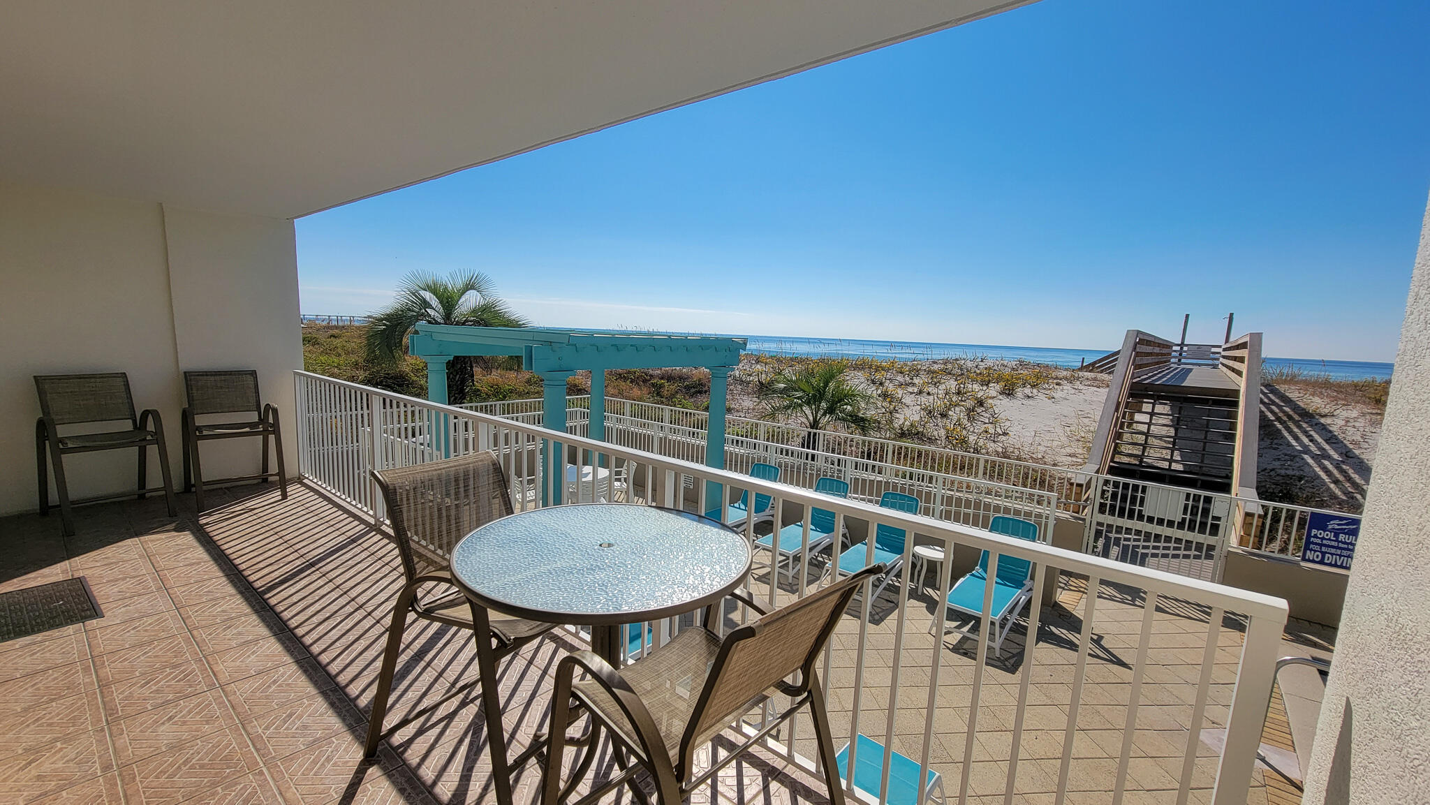 376 Santa Rosa Boulevard, Unit 115 Fort Walton Beach, FL 32548 - Photo 10 of 37 a balcony with table and chairs
