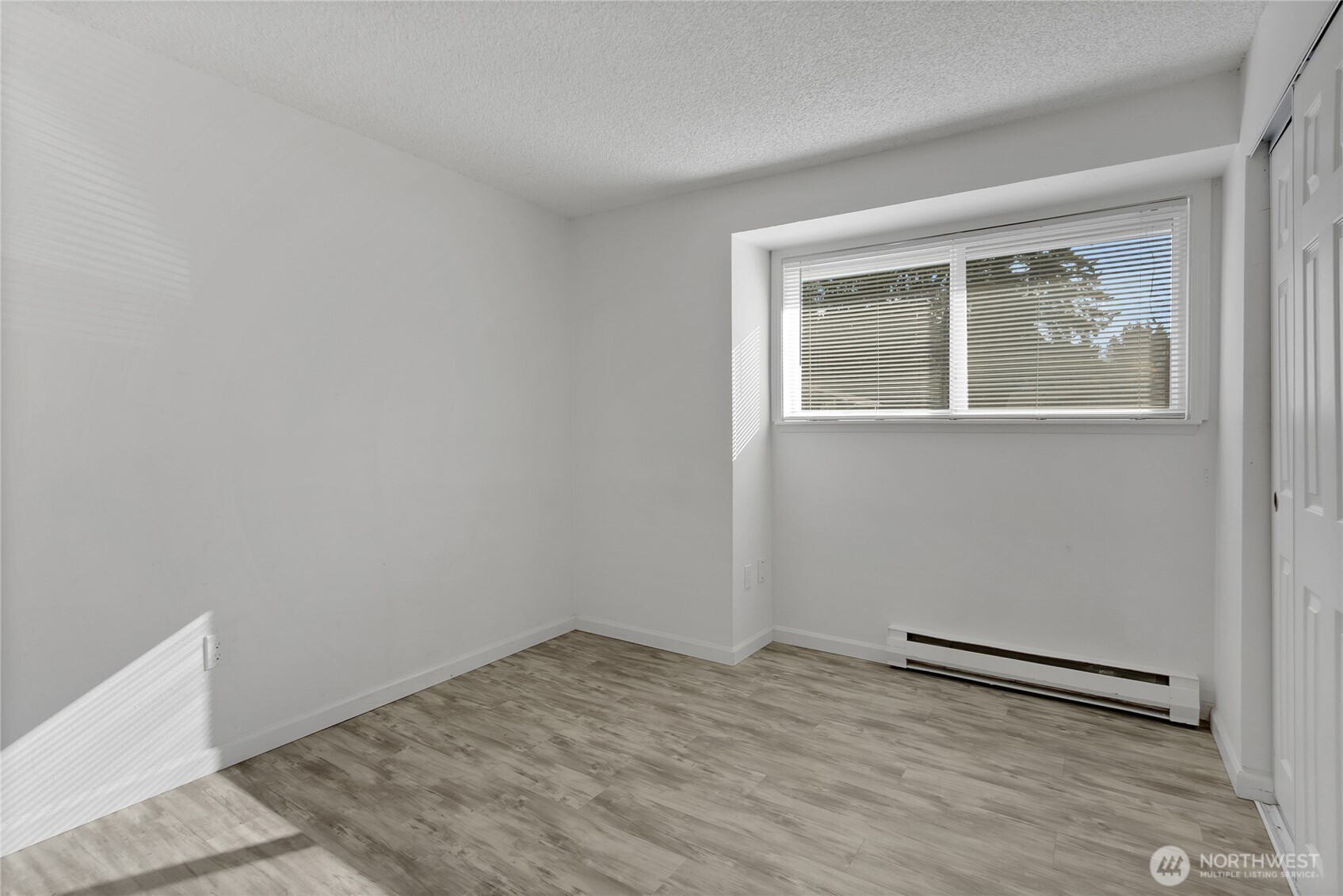 419 South 325th Place, Unit T7 Federal Way, WA 98003 - Photo 11 of 16 a view of an empty room with wooden floor and a window