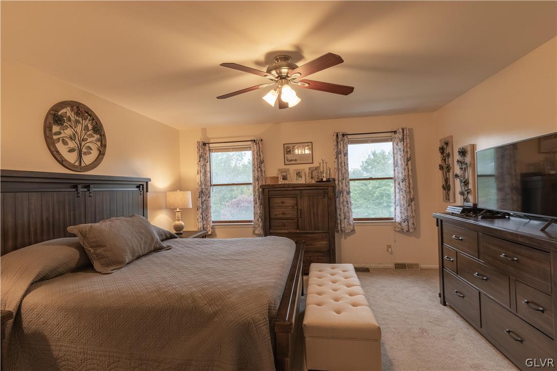 2753 Buttermilk Road Hellertown, PA 18055 - Photo 23 of 42 a bedroom with a large bed and a chandelier