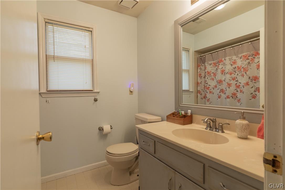 2753 Buttermilk Road Hellertown, PA 18055 - Photo 31 of 42 a bathroom with a granite countertop sink toilet and a mirror