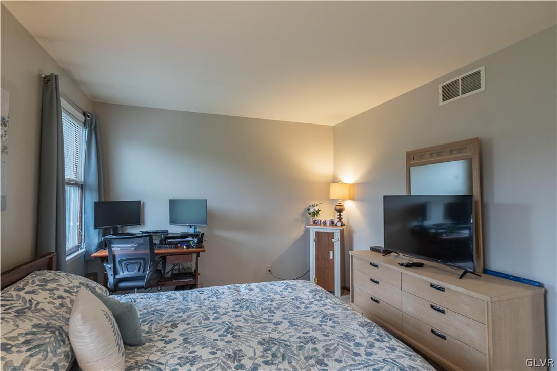 2753 Buttermilk Road Hellertown, PA 18055 - Photo 33 of 42 a bedroom with a bed and a flat screen tv