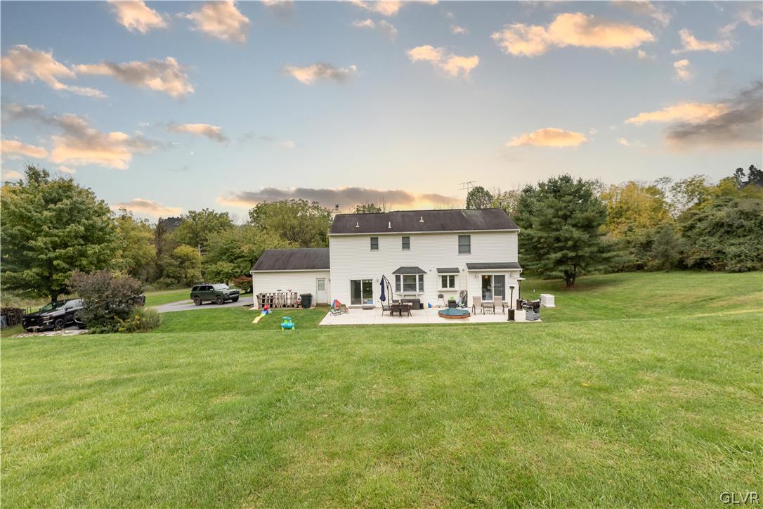 2753 Buttermilk Road Hellertown, PA 18055 - Photo 41 of 42 a view of a white house with a big yard and large trees