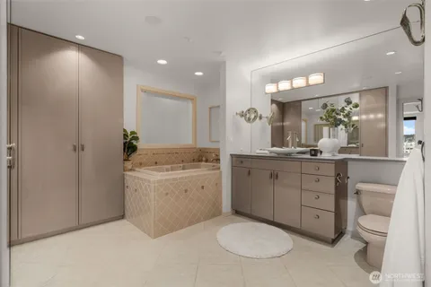 a bathroom with a granite countertop sink mirror and toilet