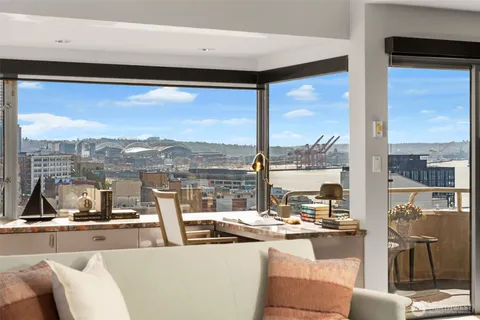 a view of a living room and floor to ceiling window or kitchen