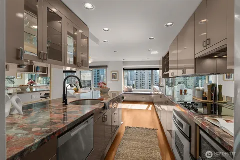 a kitchen with stainless steel appliances granite countertop counter space a sink and a stove
