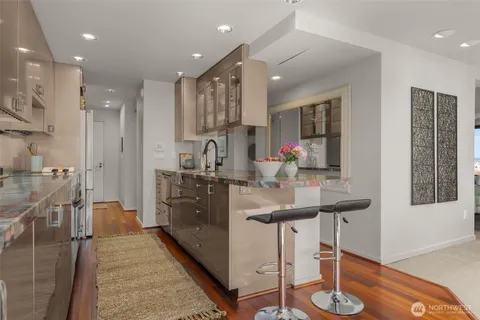 a kitchen with stainless steel appliances kitchen island granite countertop a sink and cabinets