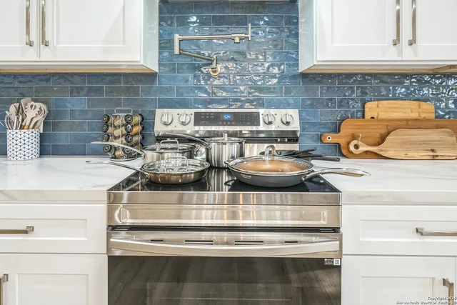 a kitchen with a stove and cabinets