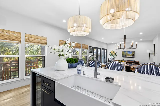 a dining room with furniture a chandelier and wooden floor