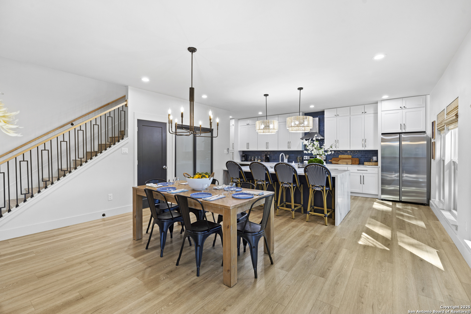 6789 River New Braunfels, TX 78132 - Photo 23 of 50 a open kitchen with stainless steel appliances granite countertop a dining table chairs refrigerator and sink