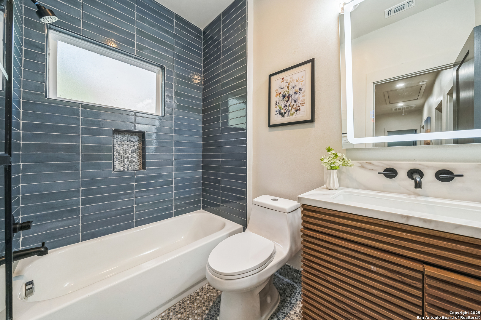 6789 River New Braunfels, TX 78132 - Photo 36 of 50 a white toilet sitting next to a bathroom sink and a bathtub