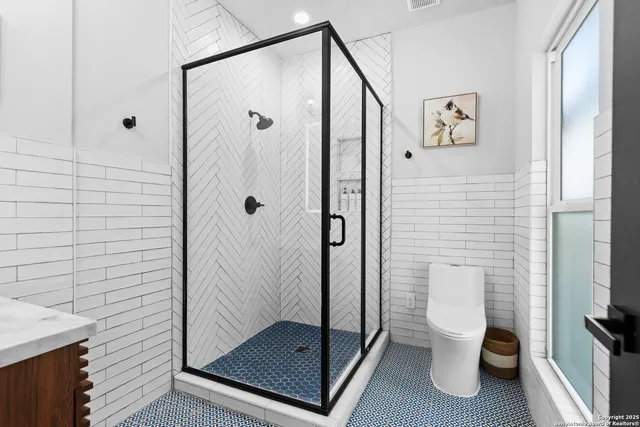 a bathroom with a shower and a toilet