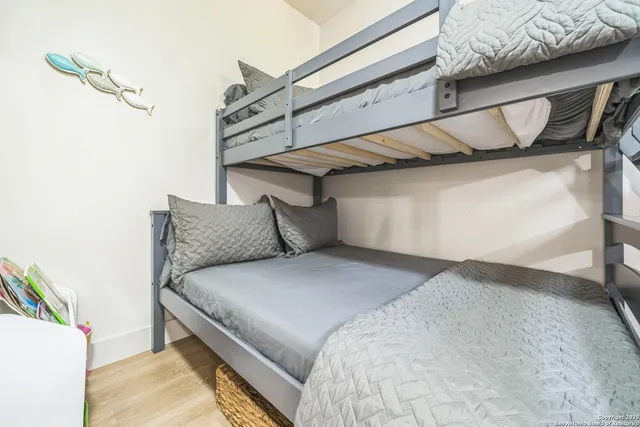 a bedroom with a bed and a wall painting