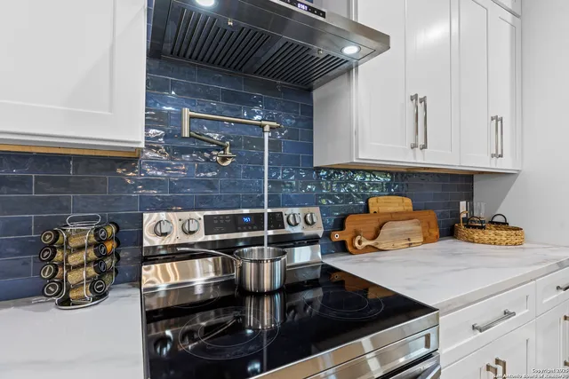 a kitchen with a stove and a cabinets