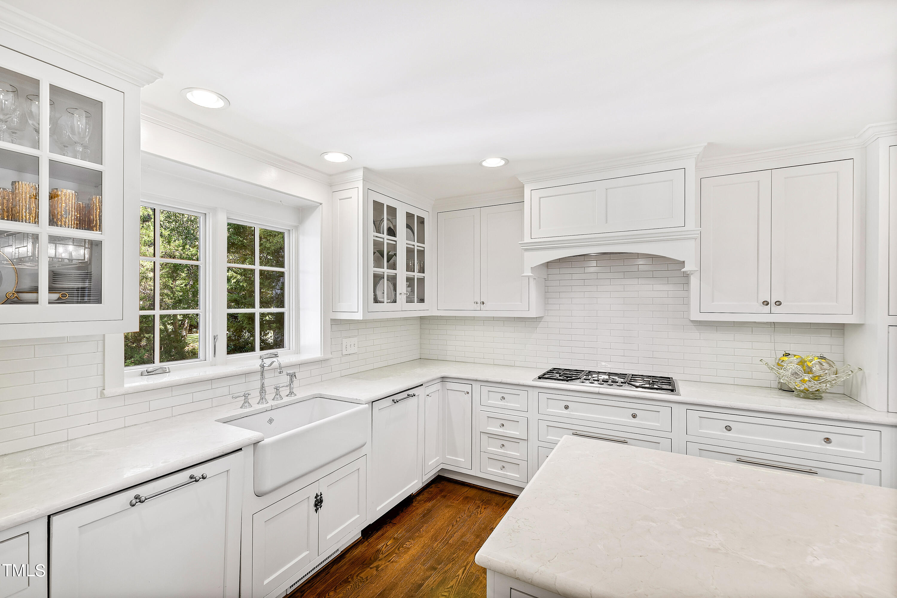 2618 Churchill Road Raleigh, NC 27608 - Photo 18 of 58 a kitchen with a sink window and cabinets
