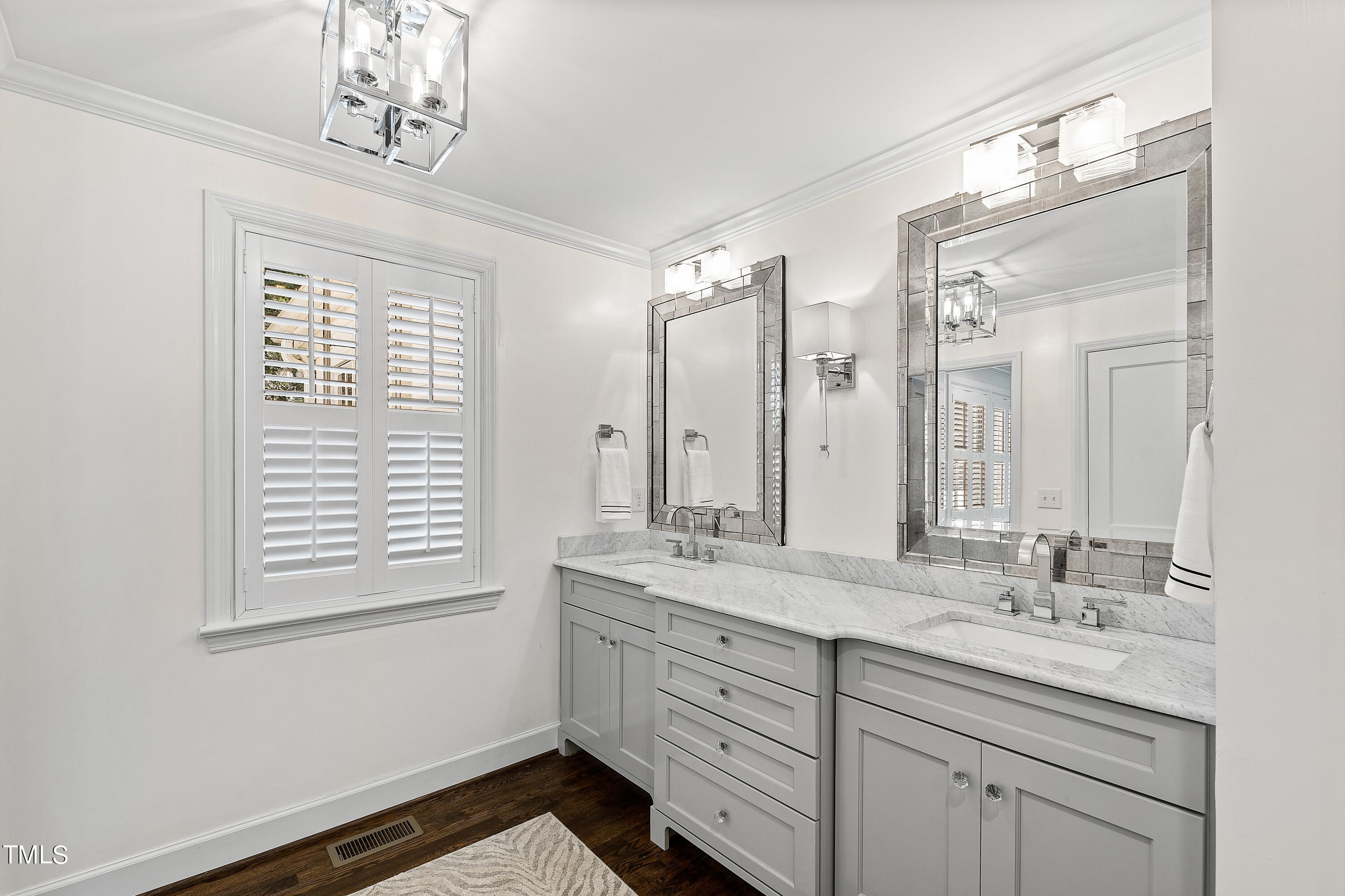 2618 Churchill Road Raleigh, NC 27608 - Photo 27 of 58 a bathroom with a double vanity sink and a mirror
