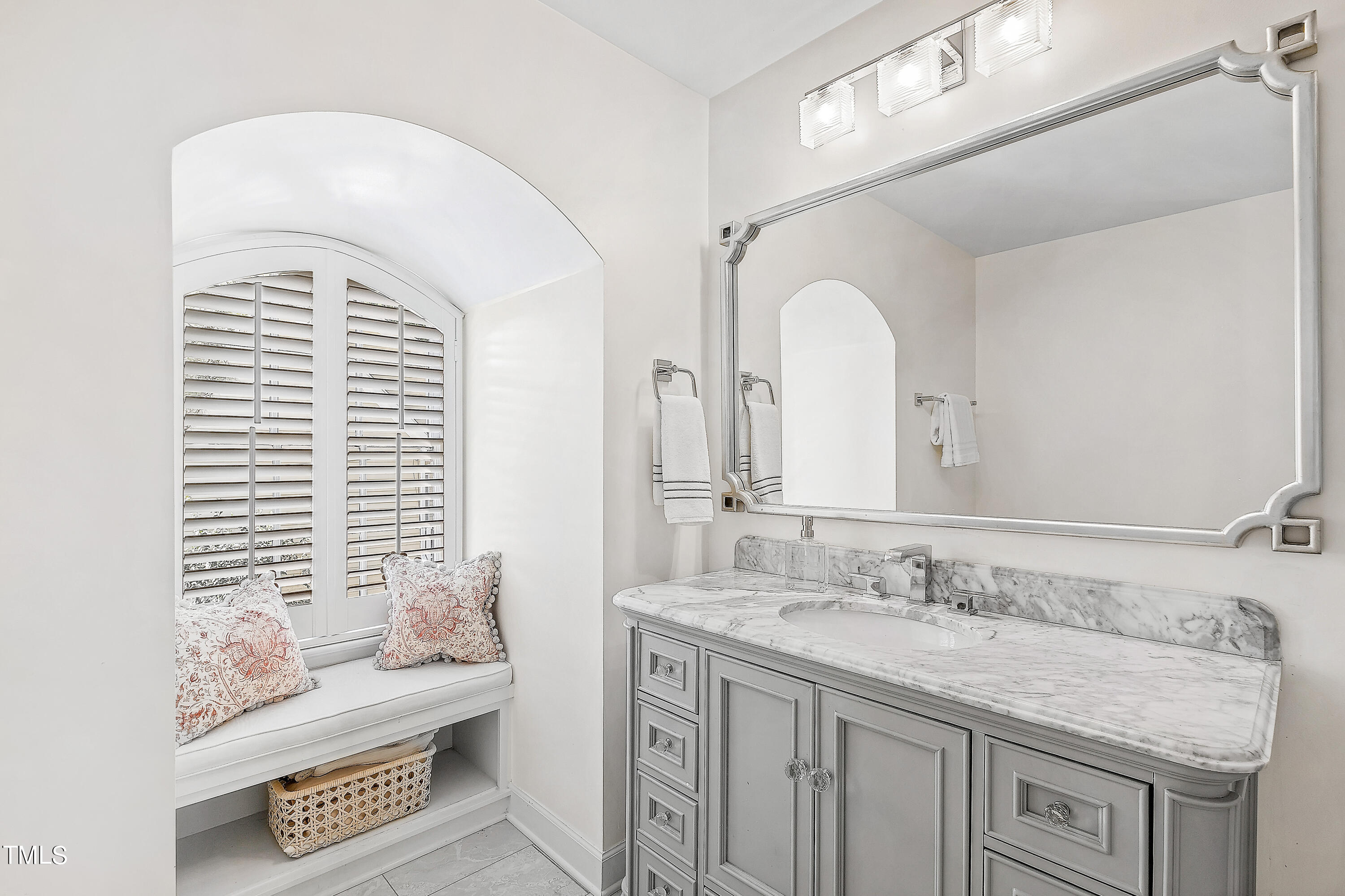 2618 Churchill Road Raleigh, NC 27608 - Photo 41 of 58 a spacious bathroom with a granite countertop sink and a mirror