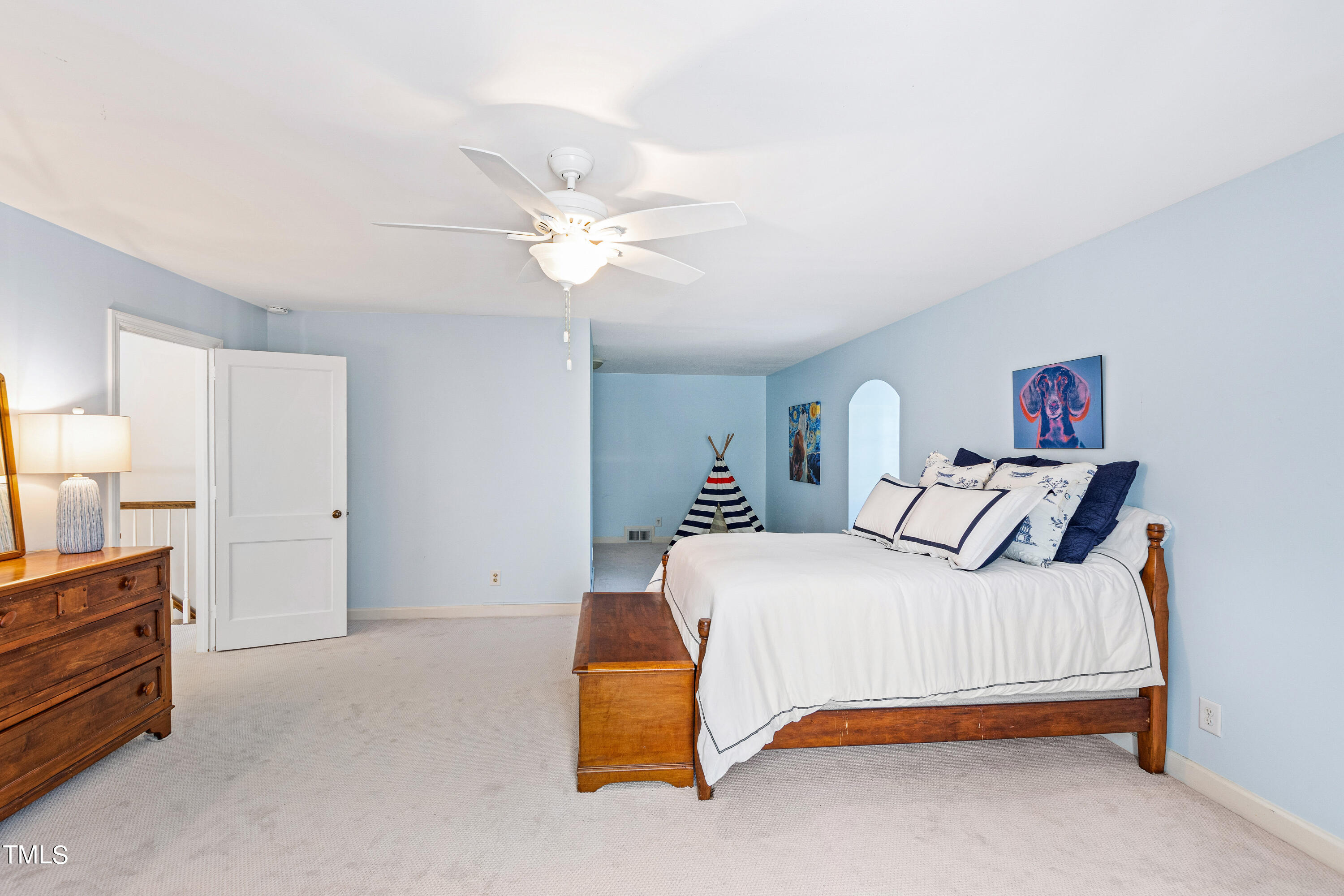 2618 Churchill Road Raleigh, NC 27608 - Photo 47 of 58 a bedroom with a bed and a chandelier