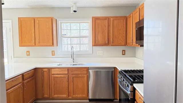 a kitchen with a sink cabinets and window