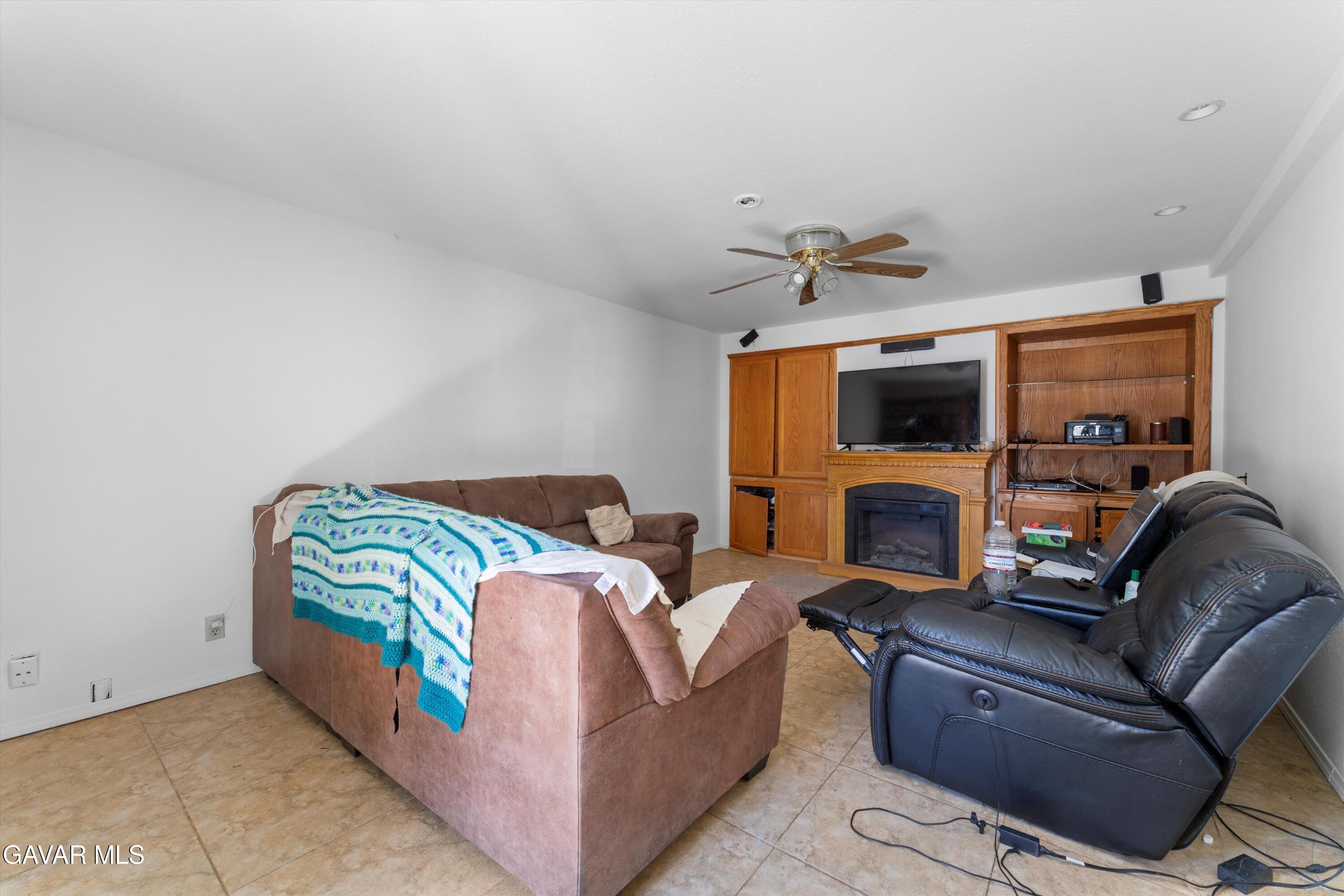 24750 Flatiron Court Tehachapi, CA 93561 - Photo 11 of 25 a living room with furniture and a flat screen tv