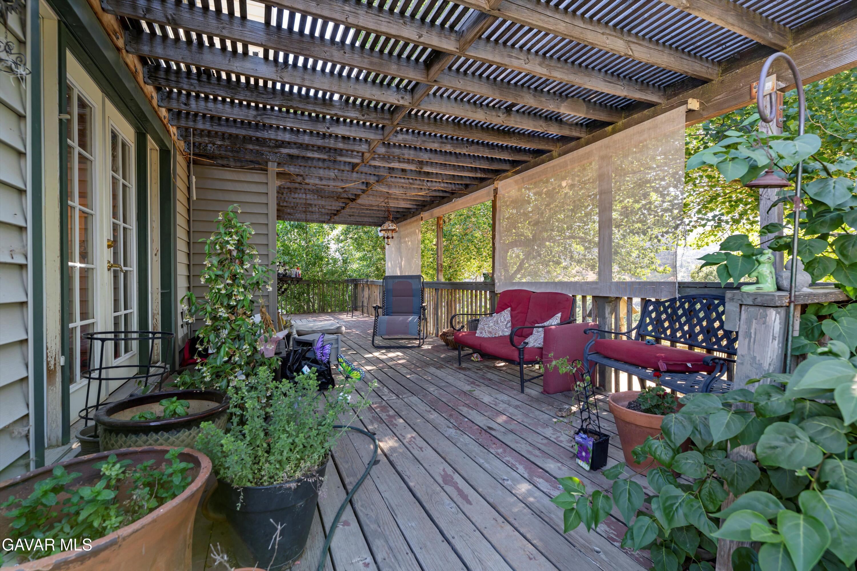 24750 Flatiron Court Tehachapi, CA 93561 - Photo 3 of 25 a view of a patio with table and chairs potted plants with wooden floor