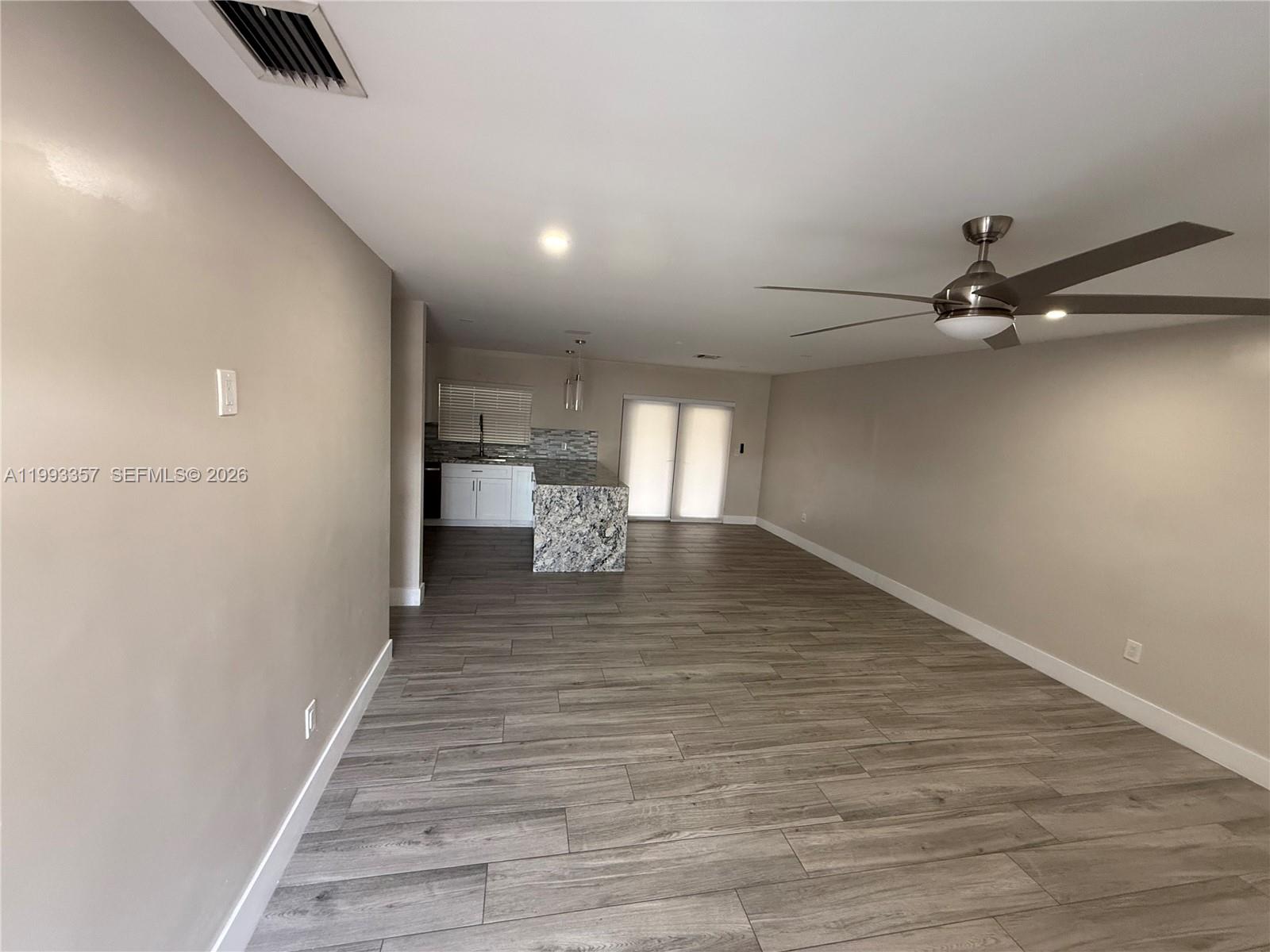 1050 West 37th Street Hialeah, FL 33012 - Photo 3 of 19 a view of a room with wooden floor and staircase