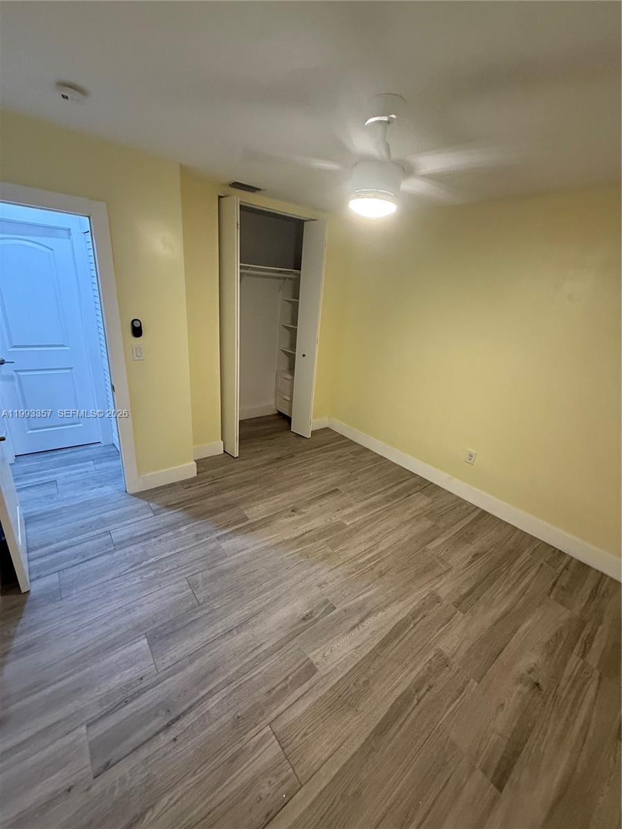 1050 West 37th Street Hialeah, FL 33012 - Photo 8 of 19 a view of an empty room with wooden floor