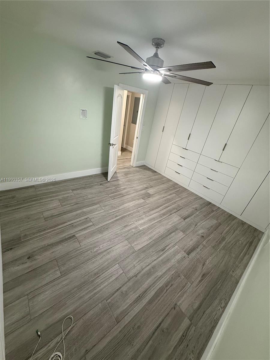 1050 West 37th Street Hialeah, FL 33012 - Photo 10 of 19 a view of an empty room with wooden floor