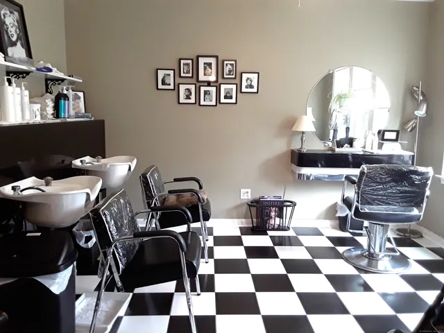 a living room with a black white checkered floor with couches chair and a dining table with wooden floor