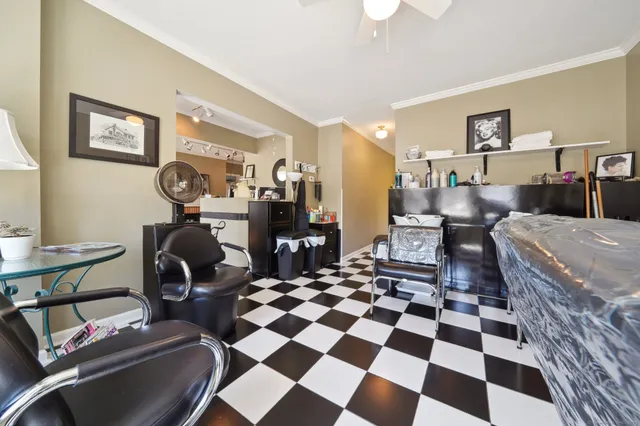 a living room with a black white checkered floor with couches chair and a coffee table