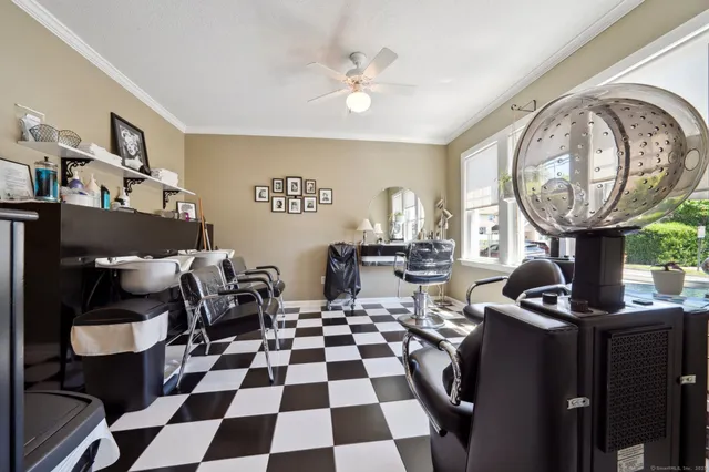 a room with furniture a rug and white walls