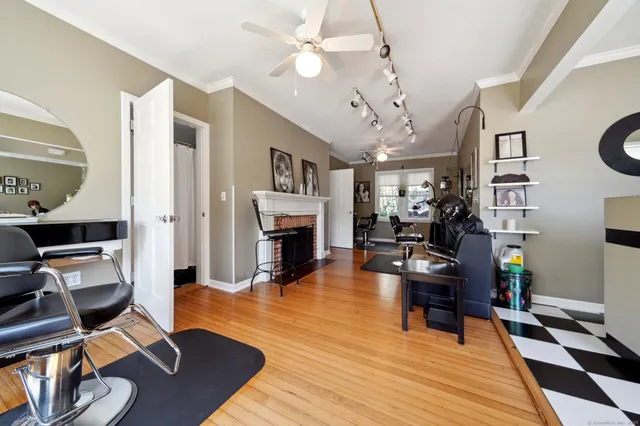 a living room with furniture a fireplace and a chandelier