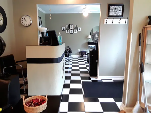 a black and white checkered floor with a rug