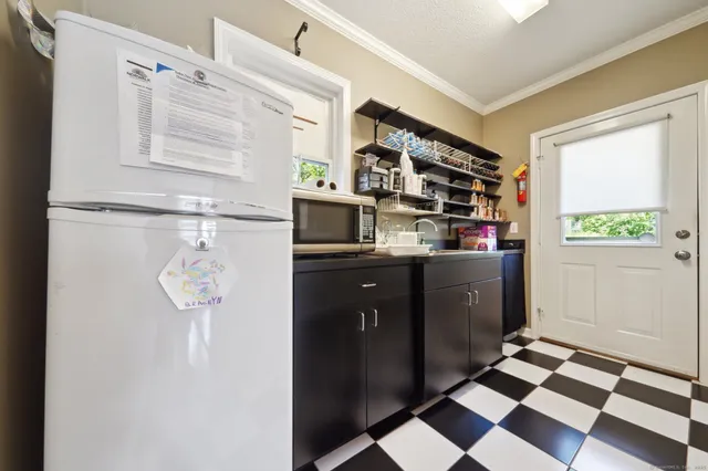 a walk in closet with wooden floor