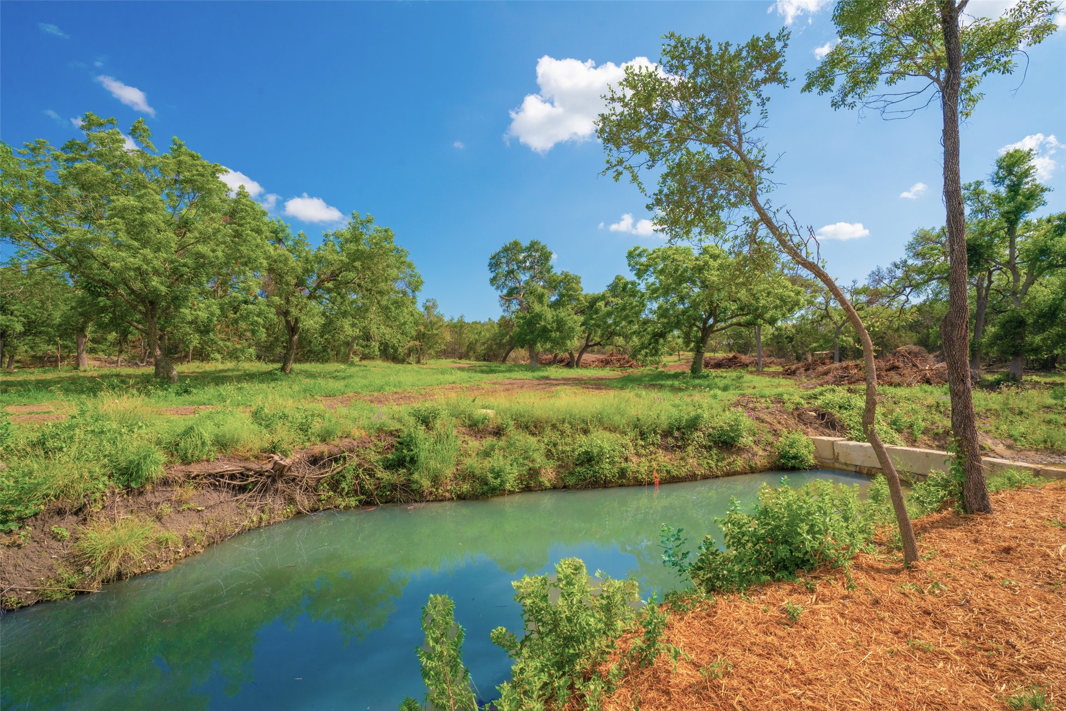 0 Spring Creek Ranch Wimberley, TX 78676 - Photo 2 of 29 a view of a lake with a yard