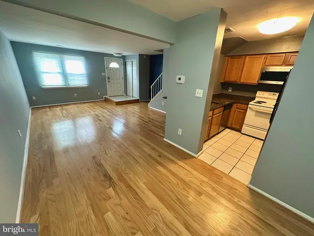 a view of a living room with wooden floor