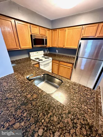 a kitchen with a sink and a stove top oven