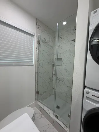 a bathroom with a shower and toilet