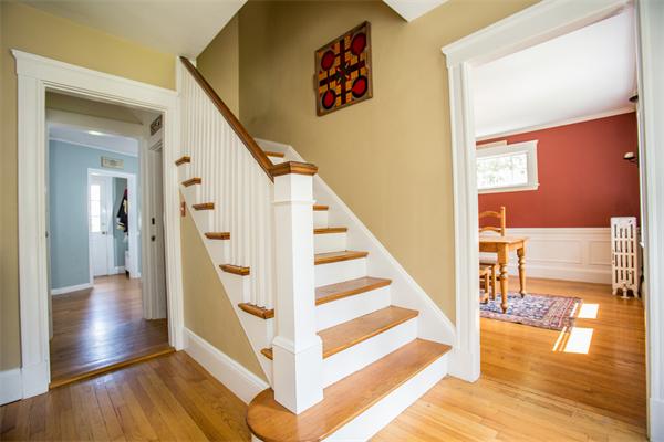 407 Weston Road Wellesley, MA 02482 - Photo 12 of 21 a view of a hallway with wooden floor and staircase
