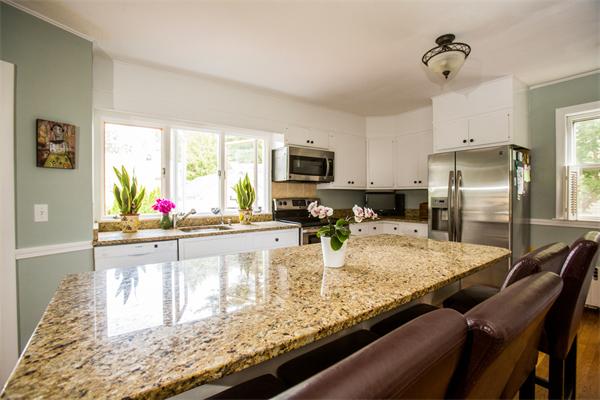 407 Weston Road Wellesley, MA 02482 - Photo 3 of 21 a kitchen with granite countertop lots of counter top space and stainless steel appliances