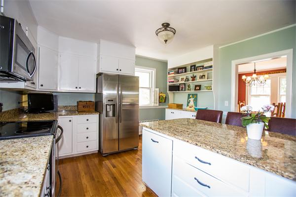 407 Weston Road Wellesley, MA 02482 - Photo 4 of 21 a kitchen with granite countertop a sink stainless steel appliances and counter space