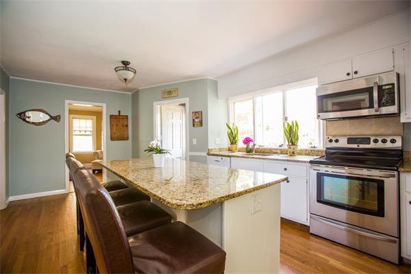 407 Weston Road Wellesley, MA 02482 - Photo 5 of 21 a kitchen with stainless steel appliances granite countertop a kitchen island hardwood floor sink stove dining table and chairs