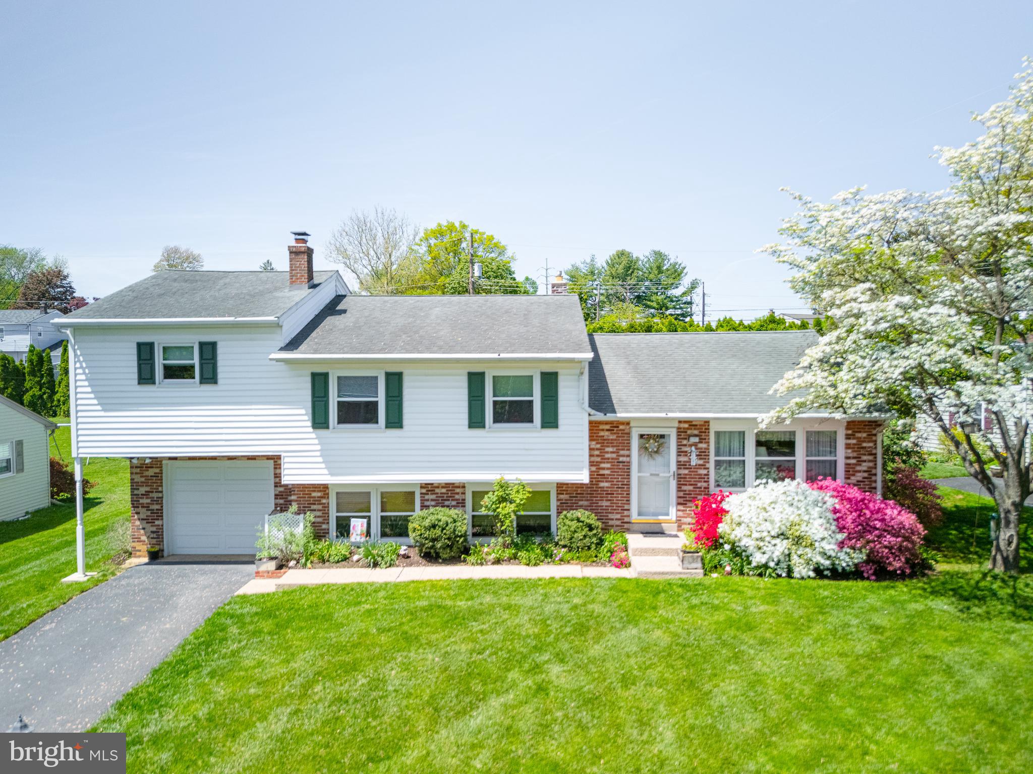 675 Gentry Drive Lancaster, PA 17603 - Photo 1 of 38 a front view of a house with a garden and yard