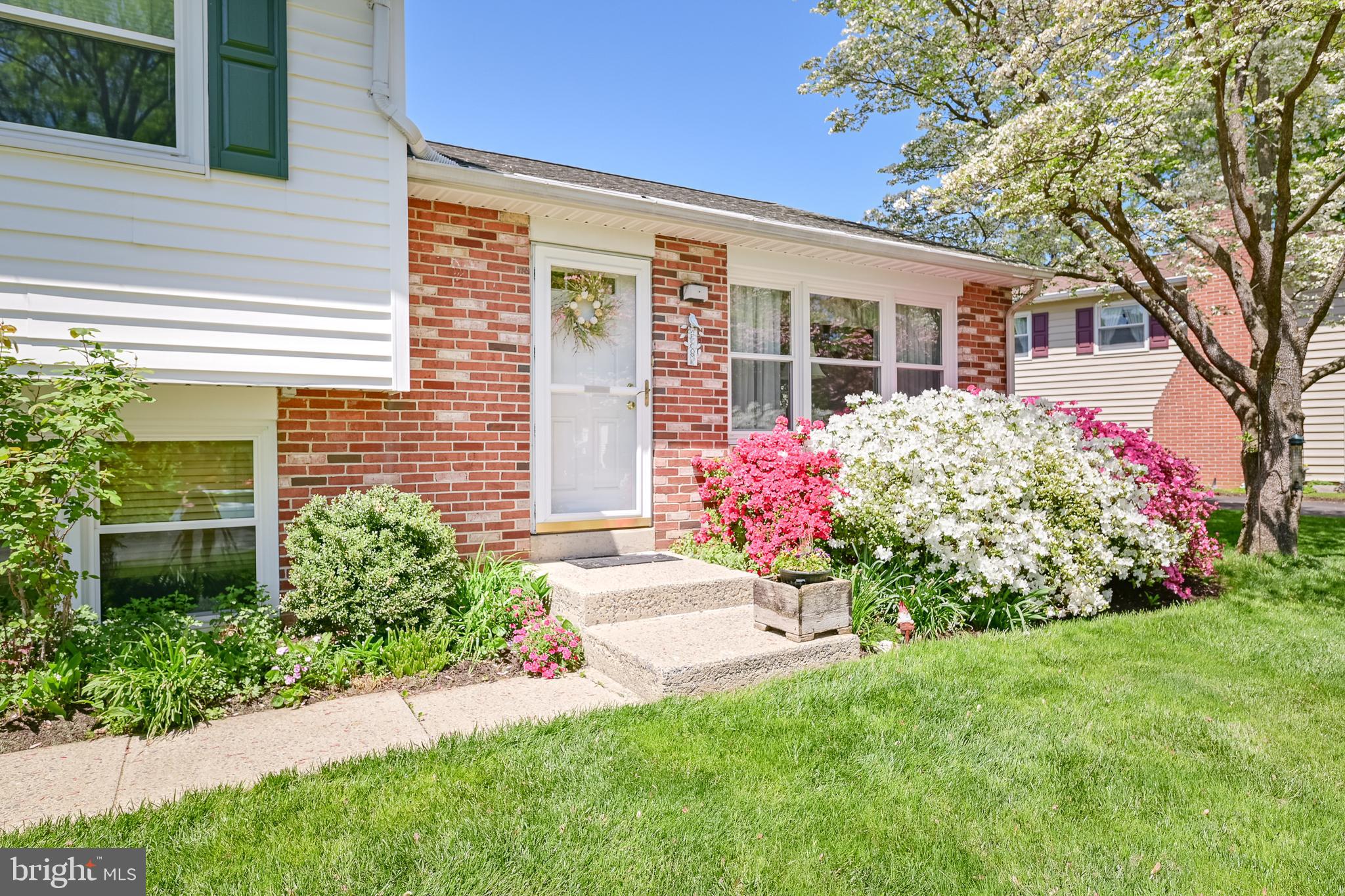 675 Gentry Drive Lancaster, PA 17603 - Photo 3 of 38 a front view of a house with a garden